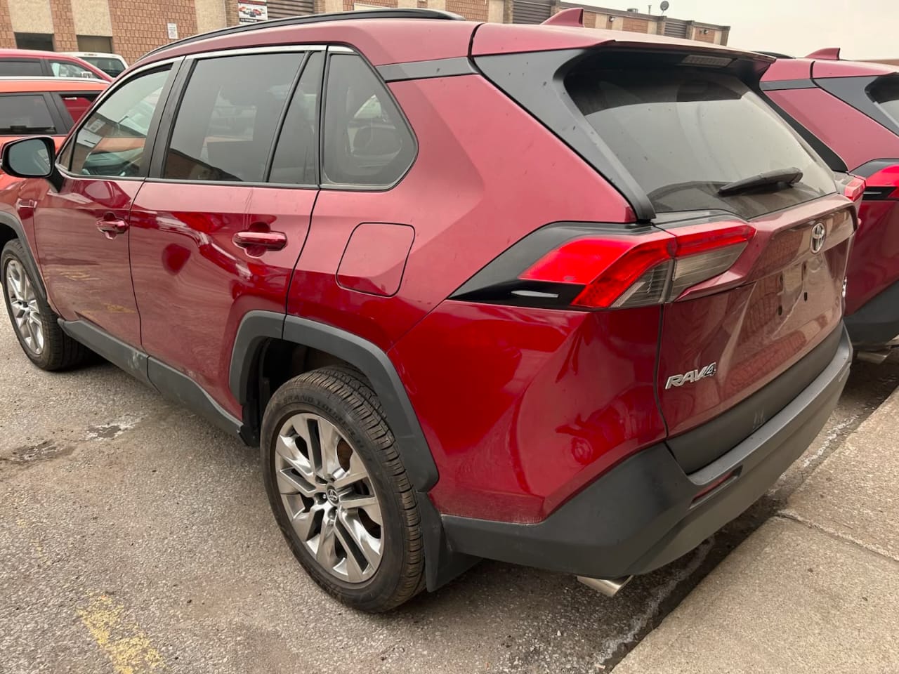 Red 2024 Toyota RAV4 side view